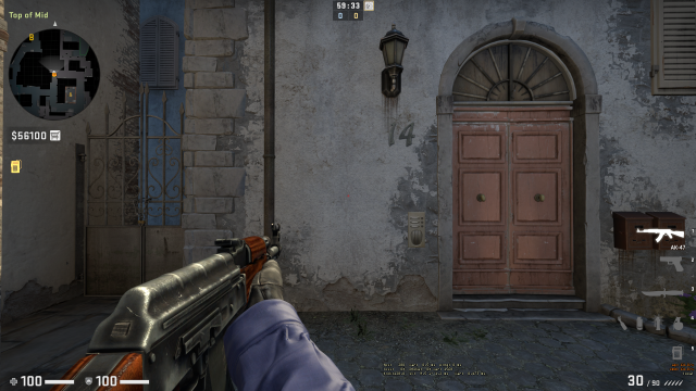 Joueur CS:GO pointant son AK-47 vers un mur sur de_inferno