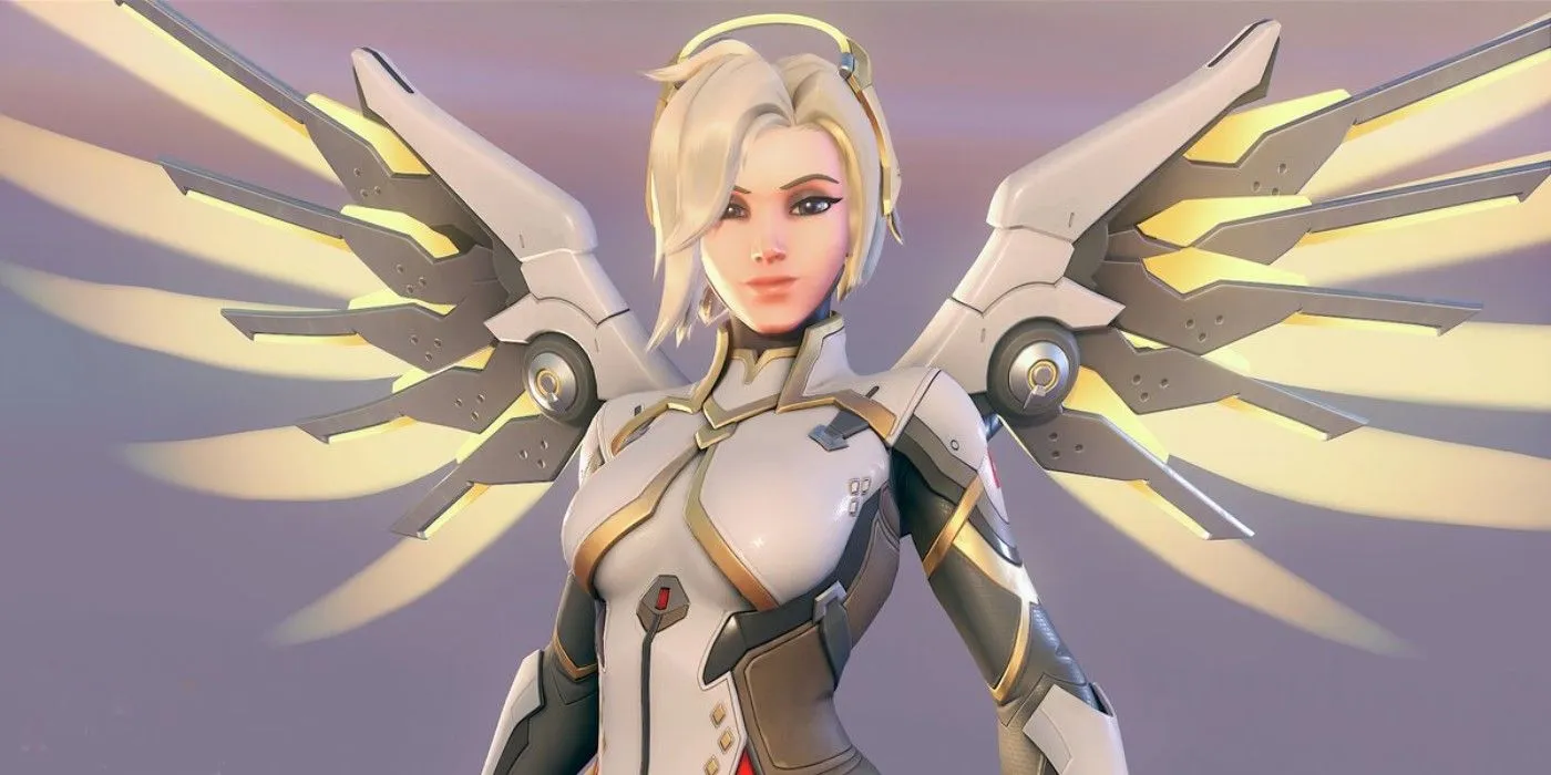 Mercy, une guérisseuse d'Overwatch 2, regarde la caméra et sourit avec ses ailes mécaniques déployées vers l'extérieur.